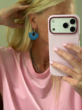 Blue fringe tassel hoop earrings worn as a lifestyle shot