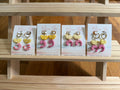 Four variations of shrimp cocktail earrings with citrus slice tops on Between Tides display cards